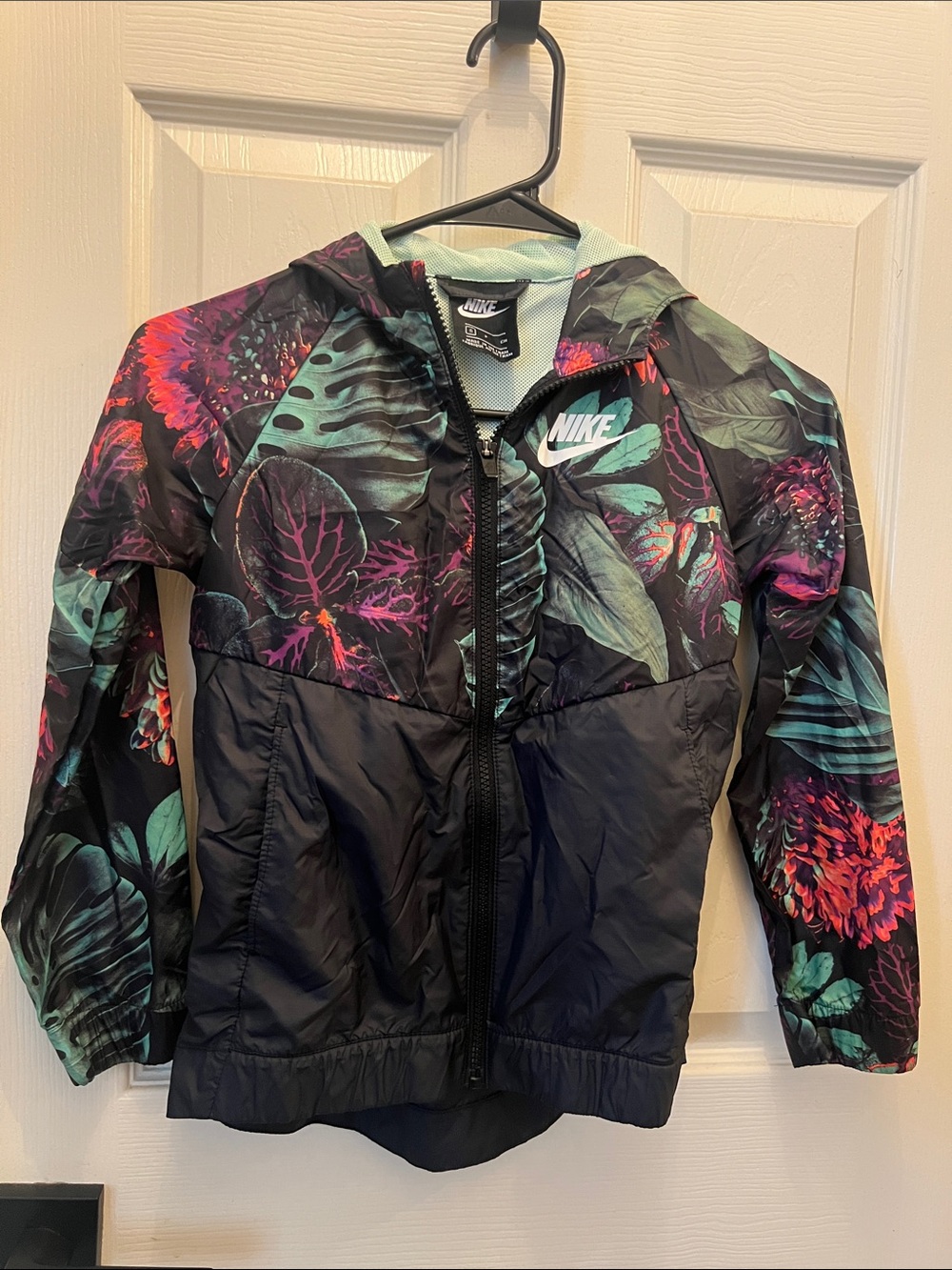 Nike Kids' Black Floral Print Hooded Rain Jacket with Teal and Purple Accents